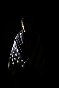 man wearing blue and white coat with black background thumbnail