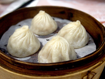 four steamed dumplings on brown bowl thumbnail