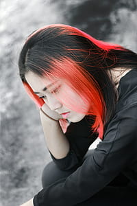 red dyed haired woman in black shirt thumbnail