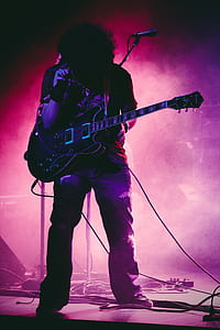 man playing guitar on stage thumbnail
