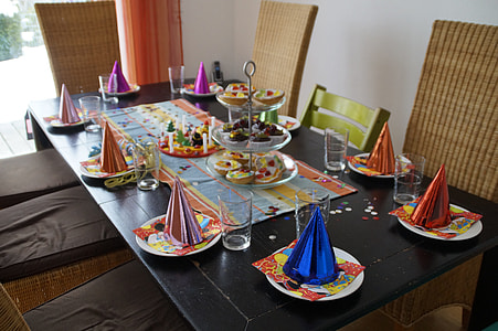 rectangular black wooden table with party treats and harts thumbnail