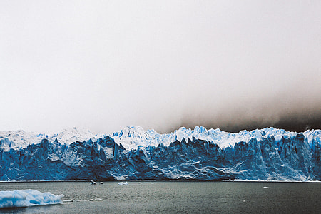 body of water with icebergs in the background thumbnail