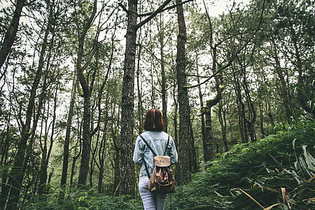 person wearing gray jacket carrying beige backpack thumbnail