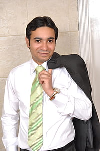 man holding black suit jacket thumbnail