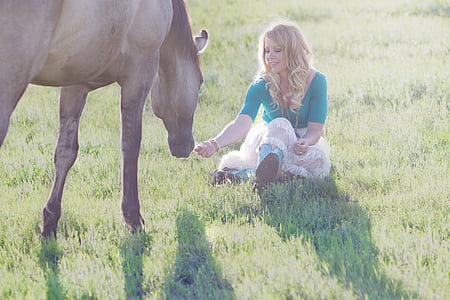 woman and horse on open grass field thumbnail
