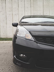 closeup photo of black car near gray wall thumbnail
