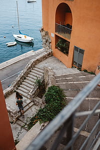 man and woman walking near stair and white boat thumbnail