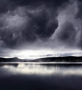 silhouette of mountains between sky and body of water thumbnail