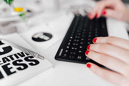 Female hands typing on the remote wireless computer keyboard thumbnail