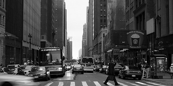 grayscale photo of person walking on pedestrian lane thumbnail