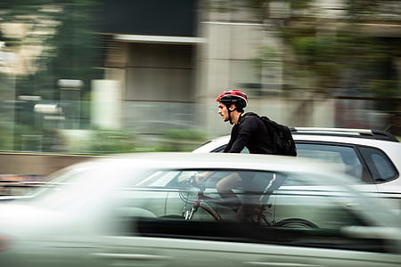panning photography of man riding bike thumbnail