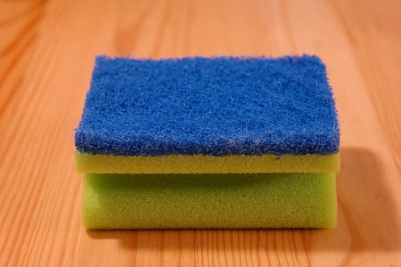 blue and yellow sponge on brown wooden surface thumbnail