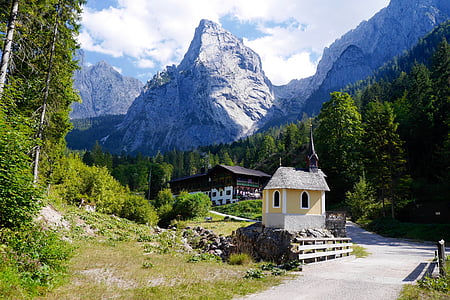 houses near tress and mountain during daytime thumbnail