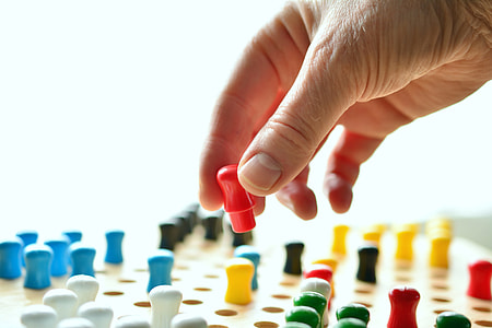 person holding multicolored plastic components thumbnail