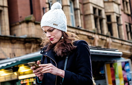 woman holding Android smartphone thumbnail