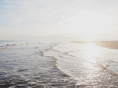 beach shore under white cloudy sky during daytime thumbnail