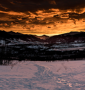 snowfield near mountain during golden hour thumbnail