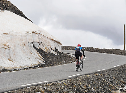 person ride on bicycle on asphalt road during daytime thumbnail