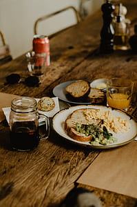 sliced bread and vegetable on ceramic plate beside clear glass mason mug thumbnail