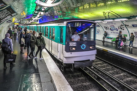 People wait for arriving train in a Paris metro station. thumbnail