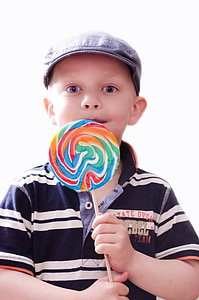 boy wearing black and white striped polo shirt holding lollipop thumbnail