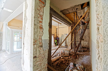 man standing in ladder holding white bucket thumbnail