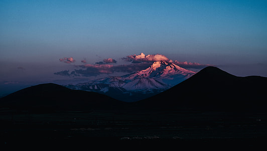 silhouette mountain photo during night time thumbnail