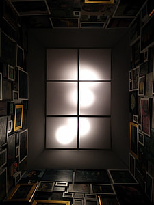 low-angle photography of room with photo frames thumbnail