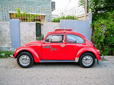 parked red Volkswagen Beetle thumbnail