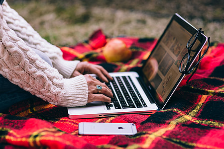 Apple Macbook on a red blanket thumbnail