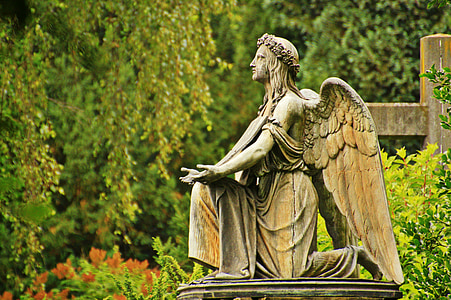 female angel statue near green trees thumbnail
