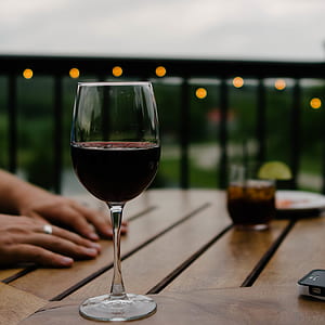 selective focus photography of wine glass with stein on table thumbnail