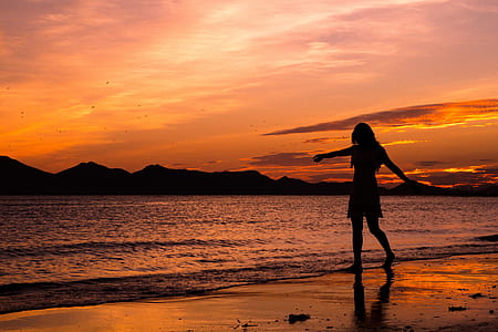 woman walking on seashore thumbnail