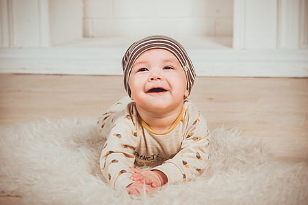 baby in brown onesie thumbnail