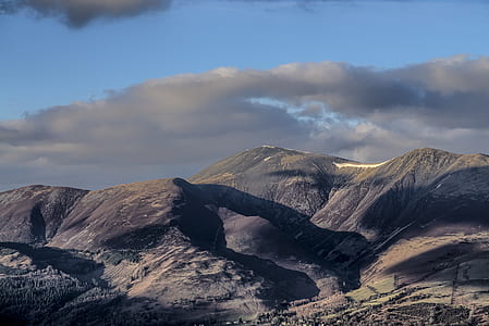 landscape photography of brown mountain under gray sky thumbnail