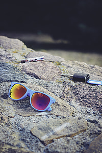 gray framed Wayfarer-style sunglasses on stone thumbnail