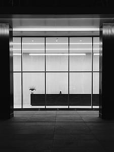 grayscale photo of building with glass wall thumbnail