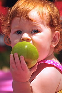closeup photo of girl eating apple thumbnail