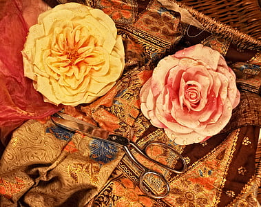 two yellow and pink flower accessories on brown floral textile thumbnail