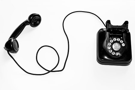 black rotary phone on white background thumbnail