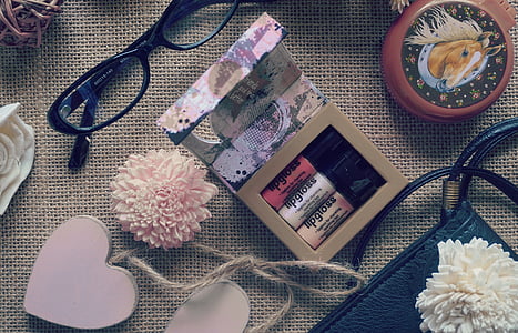 black framed eyeglasses beside cosmetic gift set box thumbnail