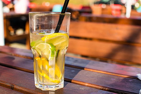 selective focus photography of clear drinking glass on brown wooden table thumbnail
