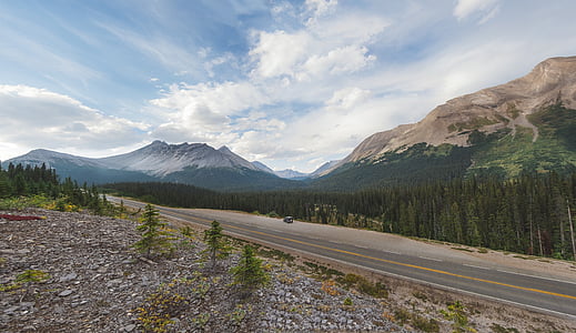 empty road in front of mountain during daytime thumbnail