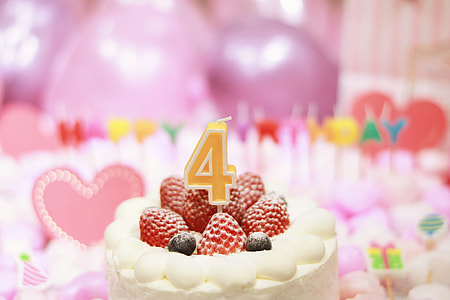 soft focus photography of 4 candle on strawberry cake thumbnail