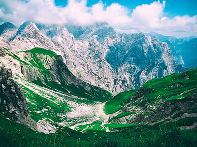landscape photography of mountains under cloudy sky thumbnail