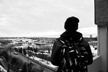 man standing on balcony thumbnail