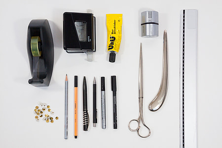 scissors, pen, tape, and tube on white surface thumbnail