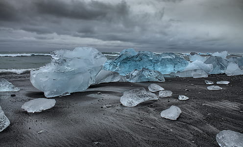 photo of ice blocks on grey sand thumbnail