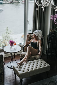 woman in black monokini sitting on armchair thumbnail