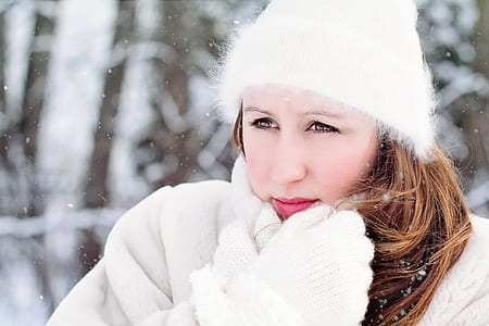 women in white beanie cap and coat portrait photography on snow terrain thumbnail